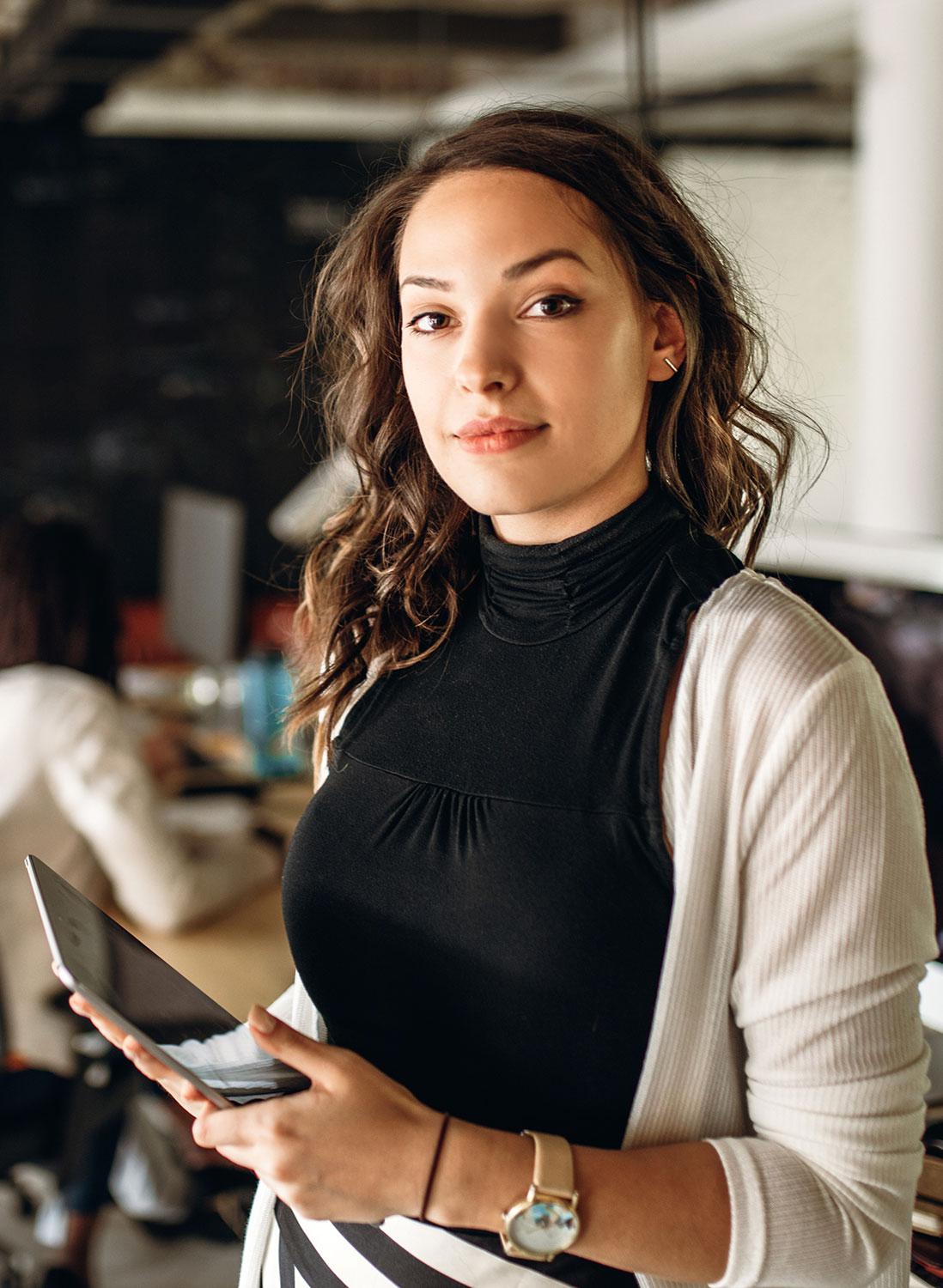 Woman holding tablet using CentralSquare computer aided dispatch software solution